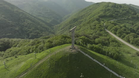 arc aerial shot of a monument in the didgori valley located in georgia