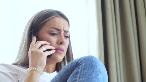 young nervous woman talking on vintage flip mobile phone, close up