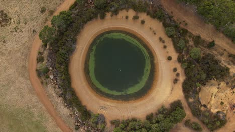 Hyperlapse drone flight of circular lagoon in nature of Western Australia during sunny day - top view