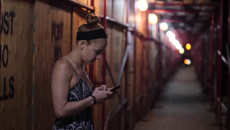 redhead woman worried with her smartphone at night in slow motion