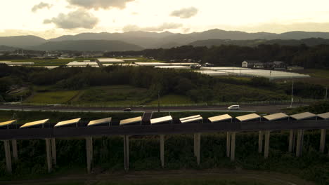 Solar-Panels-On-An-Abandoned-Monorail-Track-In-Kushu,-Japan,-Just-After-Sunset