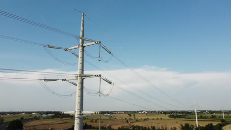 view from the drone of a new light pylon for the passage of high voltage electricity in countryside landscape and traffic car highway - increase in the cost of electricity energy  and green revolution