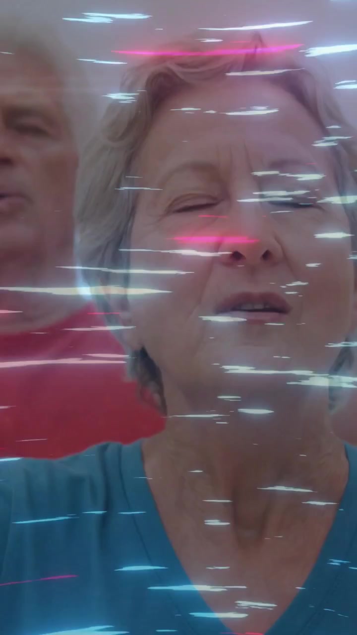 Vertical video: Senior woman singing, man mirroring, phone FX sweeping streaks over faces for tech