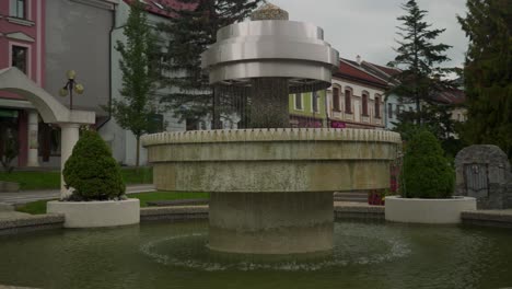 church in the middle of town shot revealing fountains