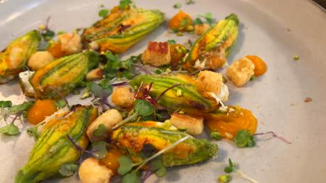 delicious stuffed squash blossoms with pumpkin puree and croutons