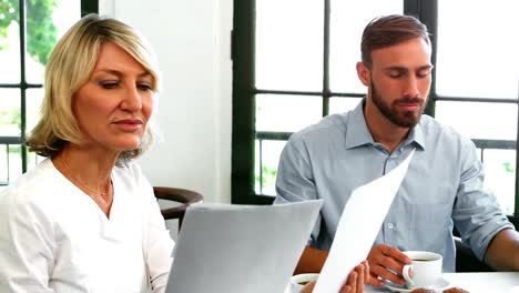 Businesspeople-discussing-over-digital-tablet