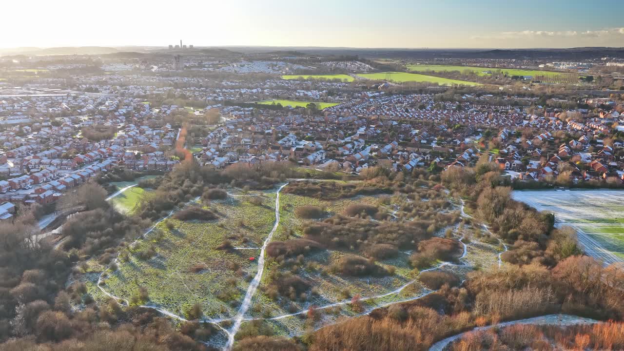 Descending aerial revealing Nottingham Forest's Wilford Lane training complex within West Bridgford's residential and recreational landscape with pitches, and Nottinghamshire countryside context