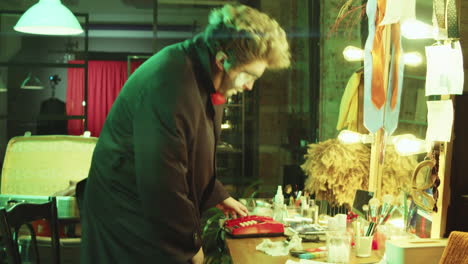 male clown speaking on phone in dressing room