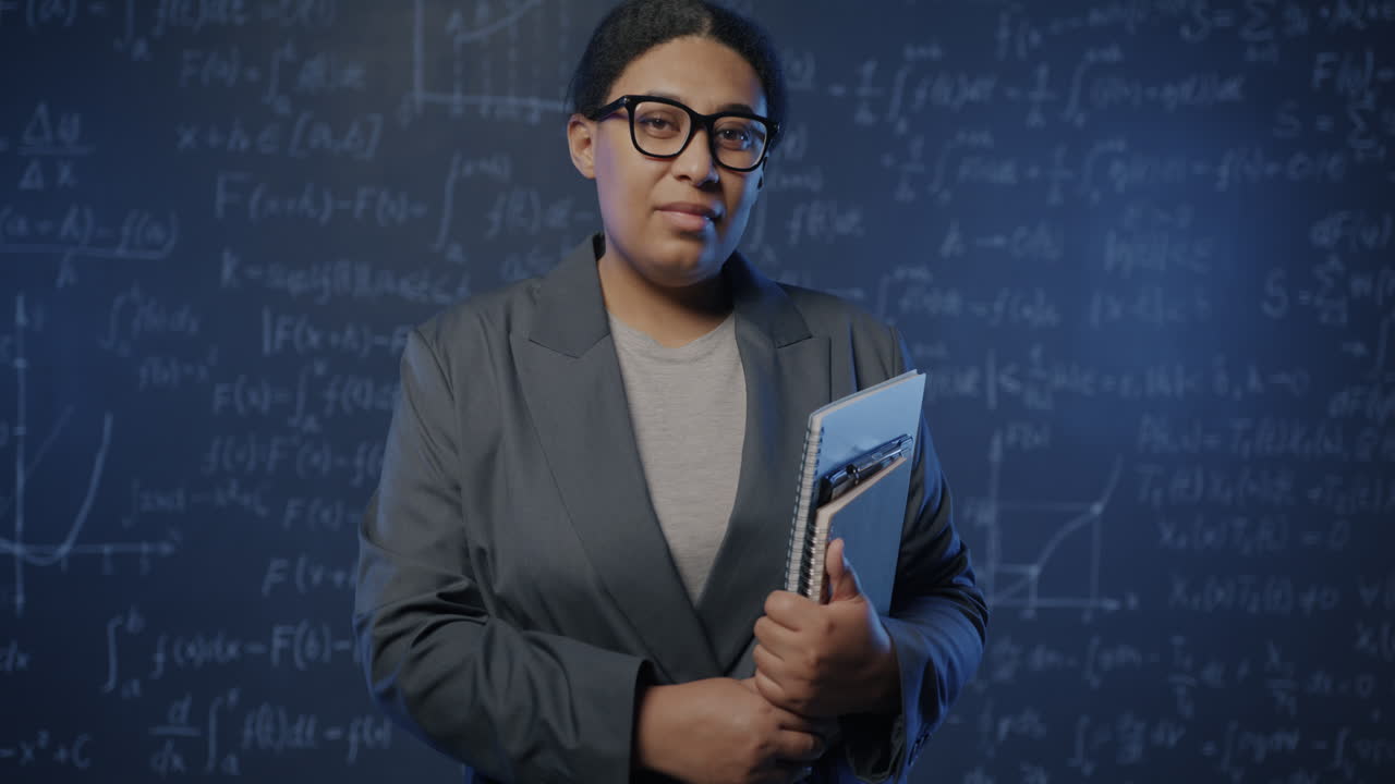 Female Professor in front of Blackboard