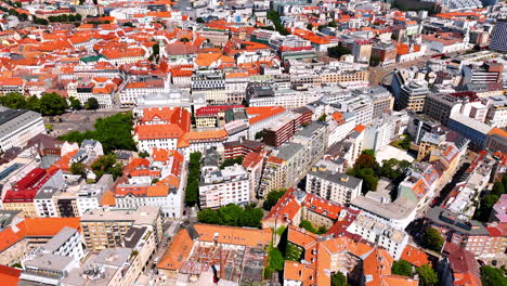 old multi-storied buildings with orange roof in the scenery of the old town. drone footage above the historical part of bratislava, slovakia.