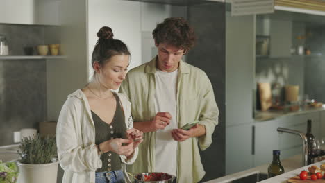 couple cooking and preparing a meal together in a modern kitchen