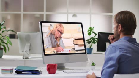 Caucasian-male-teacher-using-computer-on-video-call-with-female-student