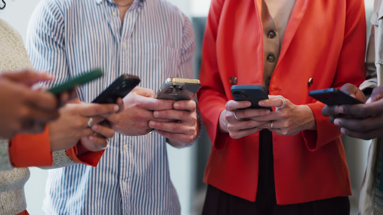 Close-up of People's Hands Interacting with Smartphones
