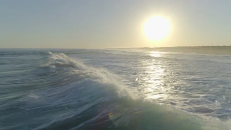 aerial shot around bodyboarder riding a wave and doing some manoeuvres, algarve