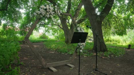 hexagonal wooden arch decorated with white roses at wedding venue