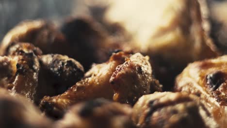 Slow-motion-close-up-shot-of-chicken-wings-and-smoke-from-the-charcoal-grill