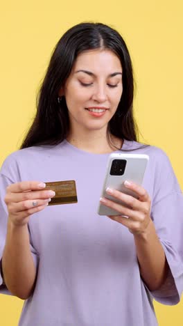 woman making an online payment with a credit card and smartphone