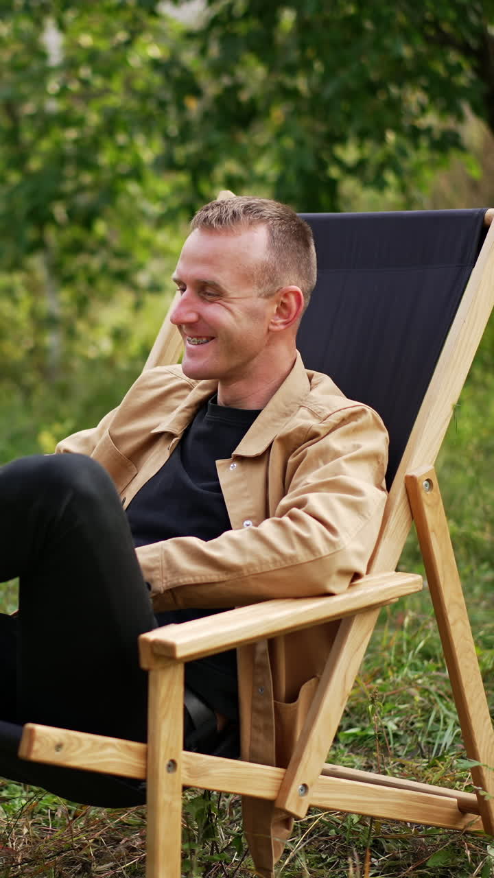 Computer working man in green nature garden. Professional manager with latop outdoor. Vertical video