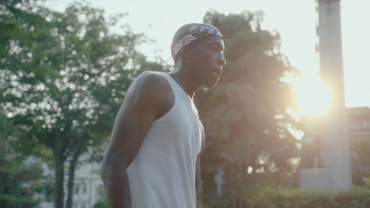 Young African American Athlete Dribbling Basketball on Outdoor Court