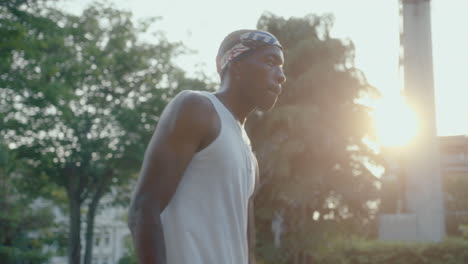 young african american athlete dribbling basketball on outdoor court