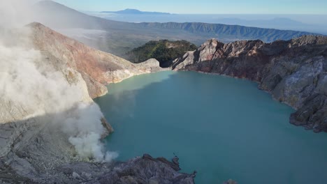 aerial view of kawah ijen volcano crater with turquoise acidic lake and sulfur mine. indonesia,asia in summer