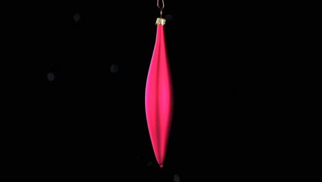 single red christmas cone ornament with black background, close up