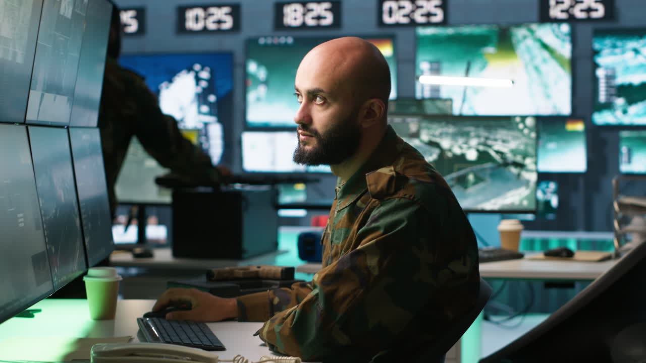 Man looking at screens in military HQ base intercepting ballistic rockets