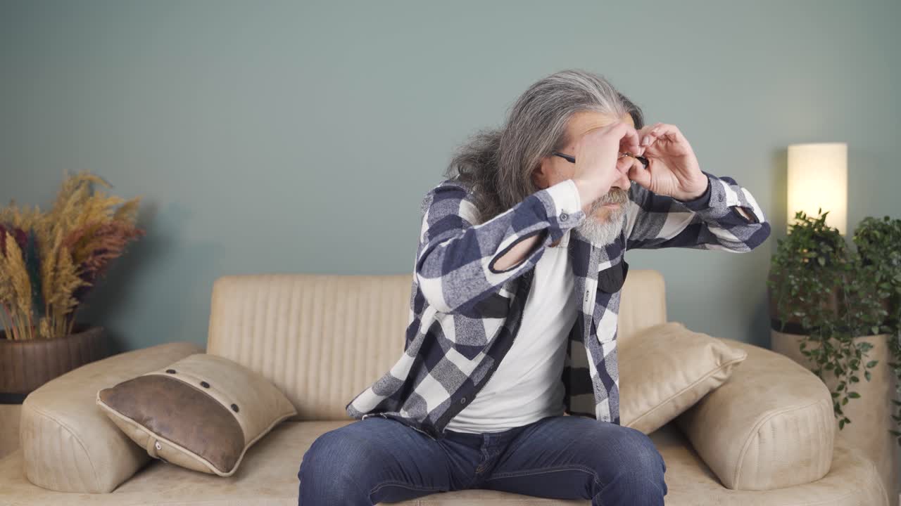 Man with binoculars looking away.