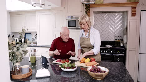 elderly couple cooking healthy meal in kitchen
