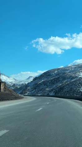 winter road trip in iran scenic mountains passing snowy hills alpine forests damavand. breathtaking landscape with winding highways rural villages autumn trees. adventure destination for travel hiking