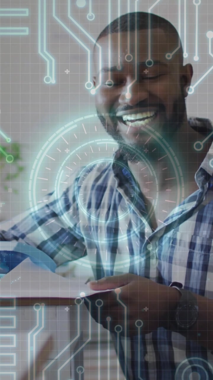Vertical video: Man picking papers and checking tech docs, HUD animating across pages showing data