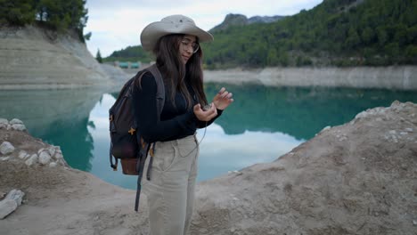 woman hiking by a mountain lake