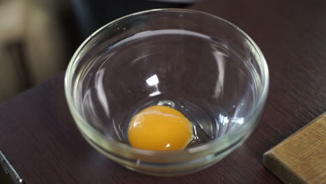 cooking food. fresh organic eggs falling into bowl. food ingredient