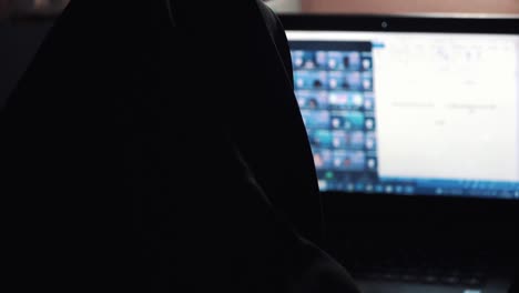 Slow-Motion---Close-up-of-a-woman-wear-veil-doing-group-zoom-meeting-with-hand-on-the-laptop-keyboard