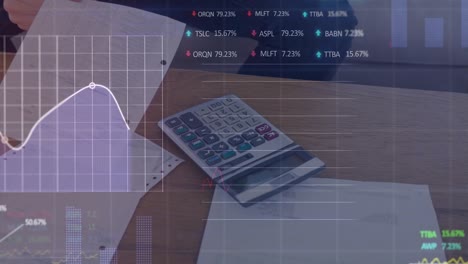 animation of financial data over documents and calculator lying on desk