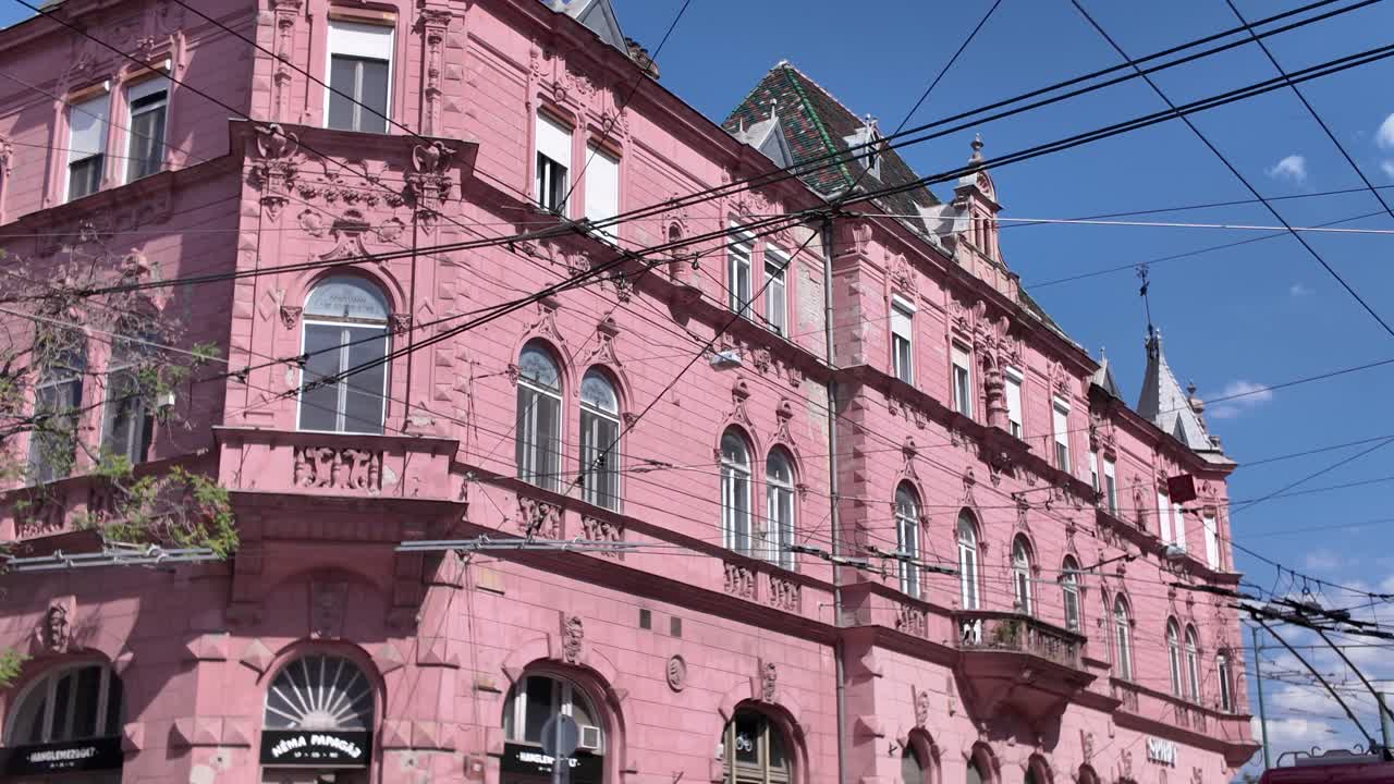 Beautiful view of Szeged’s pink historic building, highlighting its elegant design and vibrant color