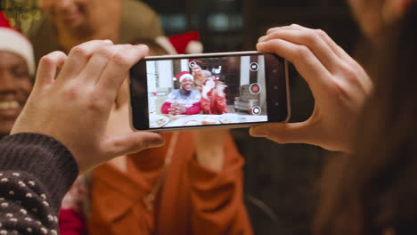 Person-taking-photo-to-happy-friends