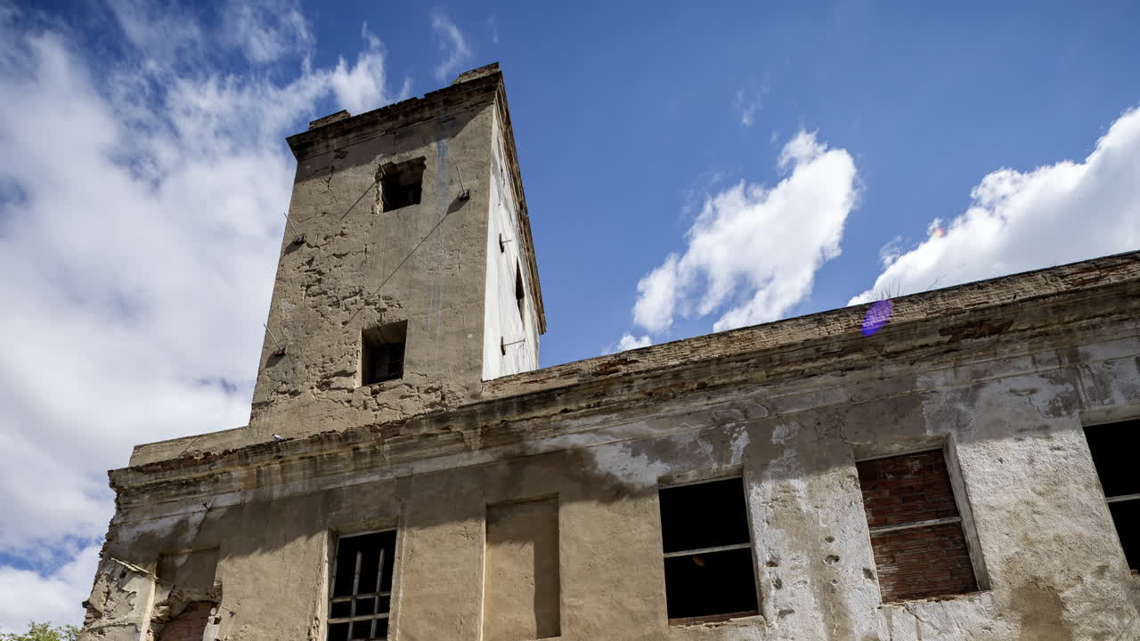 Old factory and industrial complex with passing clouds