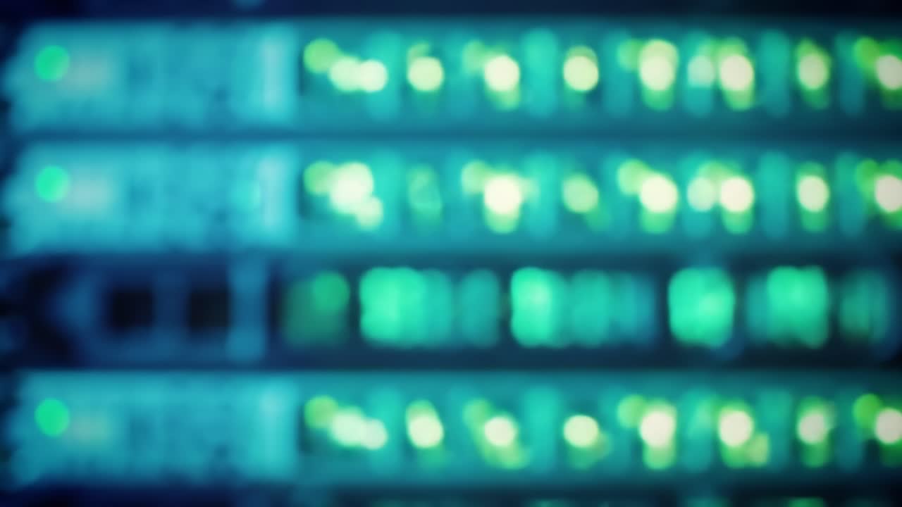 This clip showcases a bustling data center, featuring rows of illuminated servers.