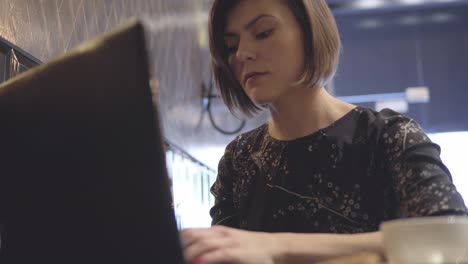 Mujer-Trabajando-En-Su-Computadora-Portátil-Y-Disfrutando-De-Su-Café