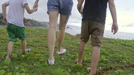 mother and sons enjoying view over beach