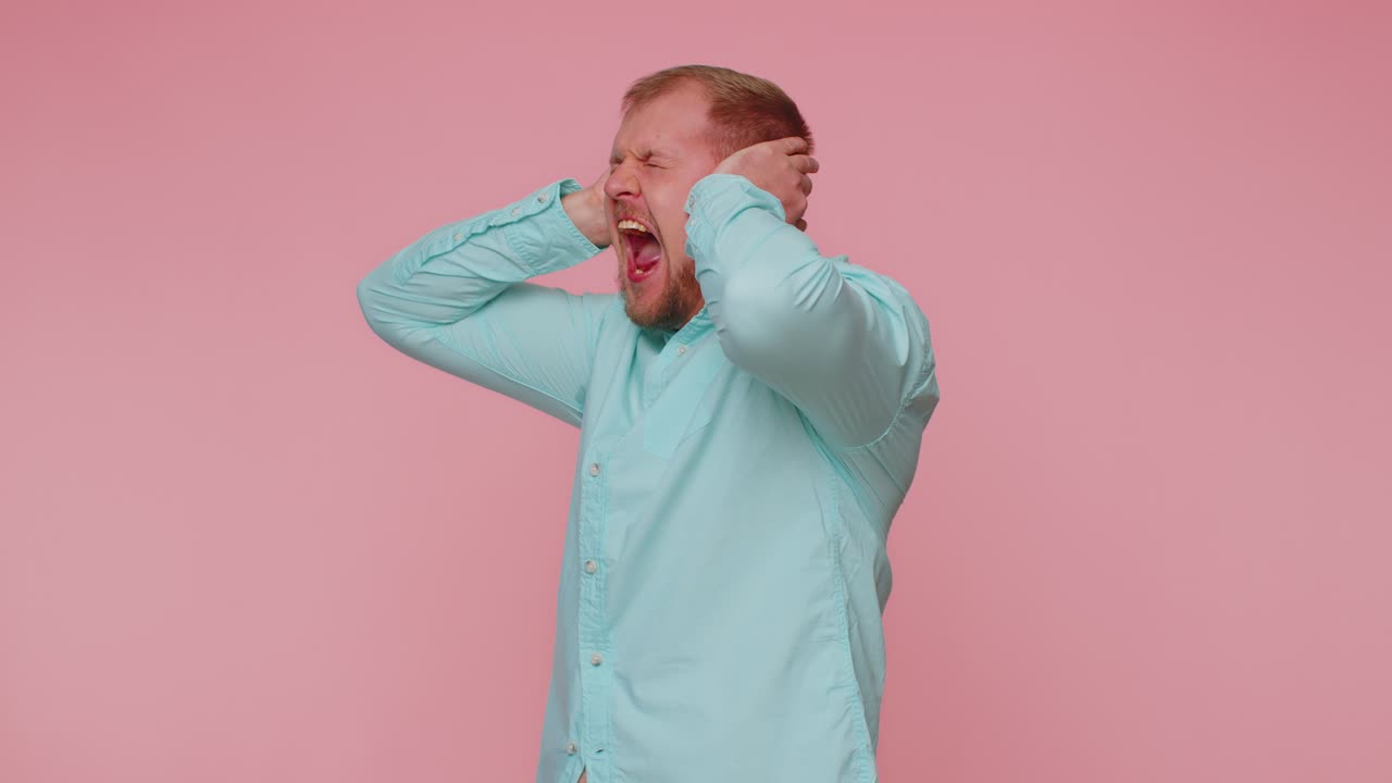 Man scared fearful covering ears meeting his own phobia evidence horror event screaming loud