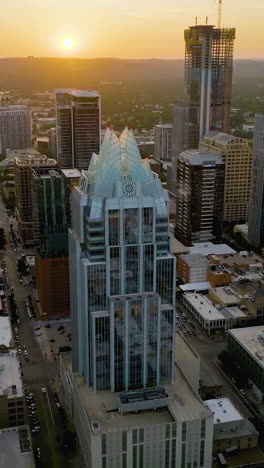 vertical drone shot tracking in front of downtown austin, sunset in texas, usa
