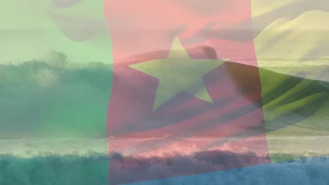 Animación-De-La-Bandera-De-Camerún-Ondeando-Sobre-El-Paisaje-Marino-De-La-Playa.