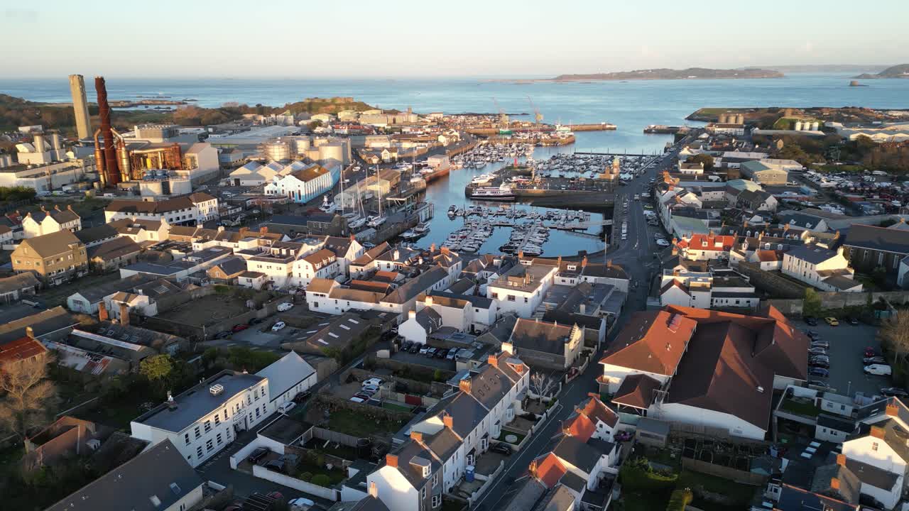 Flight over St Sampson Guernsey from Leale&rsquo;s yard to the sea showing urbanisation,marina, boatyard,power station, ship,docks cranes, Vale Castle and views out to sea and Herm on calm sunny day