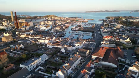 flight over st sampson guernsey from leale’s yard to the sea showing urbanisation,marina, boatyard,power station, ship,docks cranes, vale castle and views out to sea and herm on calm sunny day