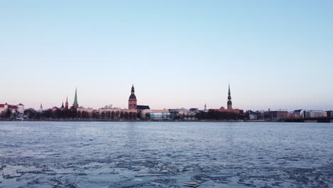 iced frozen daugava river in riga, latvia, static establisher view, dusk