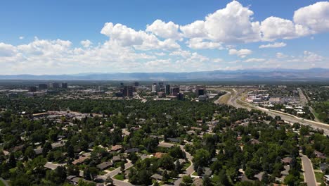 a beautiful summer landscape with blue sky and puffy clouds over the city of denver, colorado, usa