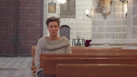 beautiful mature woman sits in empty church