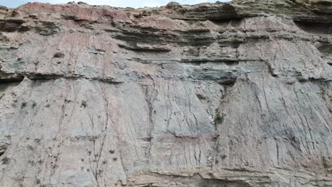 rugged-coast-line-close-up-view,-bottom-to-top,-4k